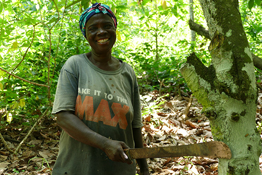 Woman with a tool in a forest.